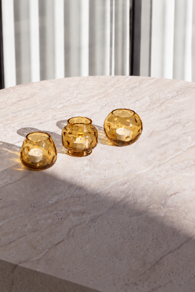 Golden amber tealight trio in sunlight